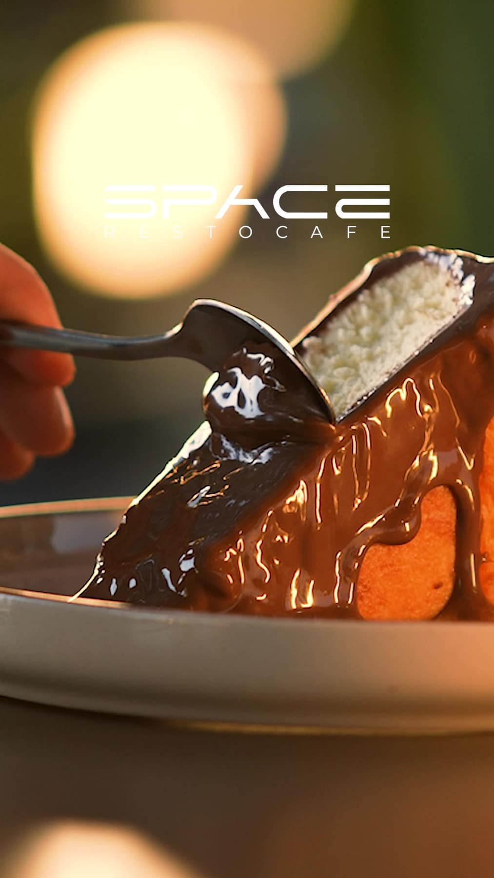 A bite of chocolate-drizzled dessert at SPACE Restocafe